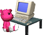frustrated pink teddy bear sitting at a computer